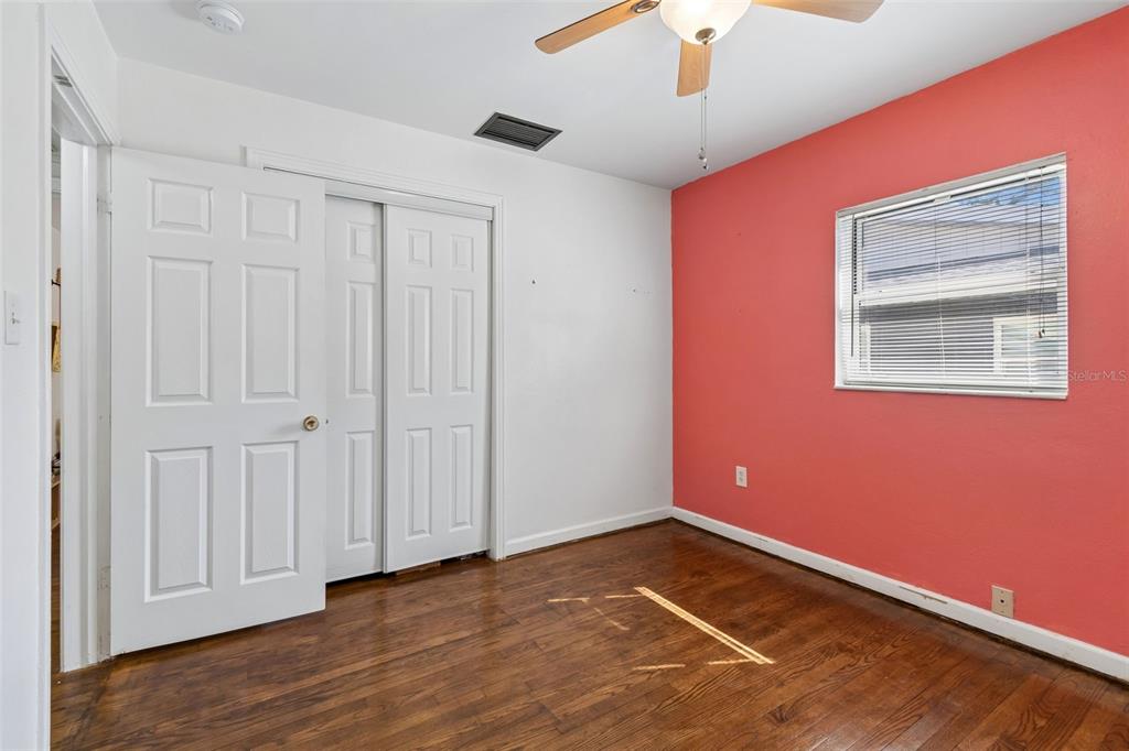 6226 8th Avenue South Gulfport, FL 33707 - Photo 30 of 46 a view of an empty room with wooden floor and a ceiling fan