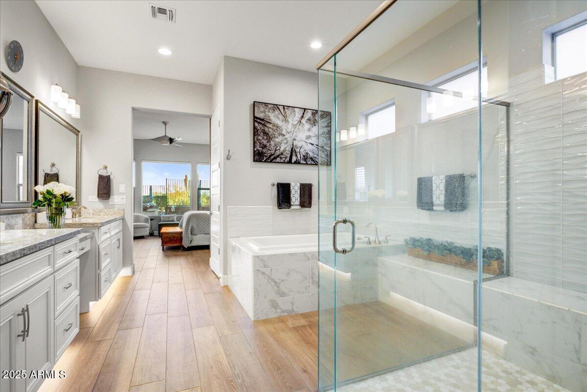17833 East StockingTrail Rio Verde, AZ 85263 - Photo 18 of 45 a bathroom with a tub a sink a mirror and a shower