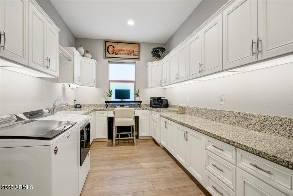 17833 East StockingTrail Rio Verde, AZ 85263 - Photo 28 of 45 a kitchen with granite countertop sink stainless steel appliances and white cabinets