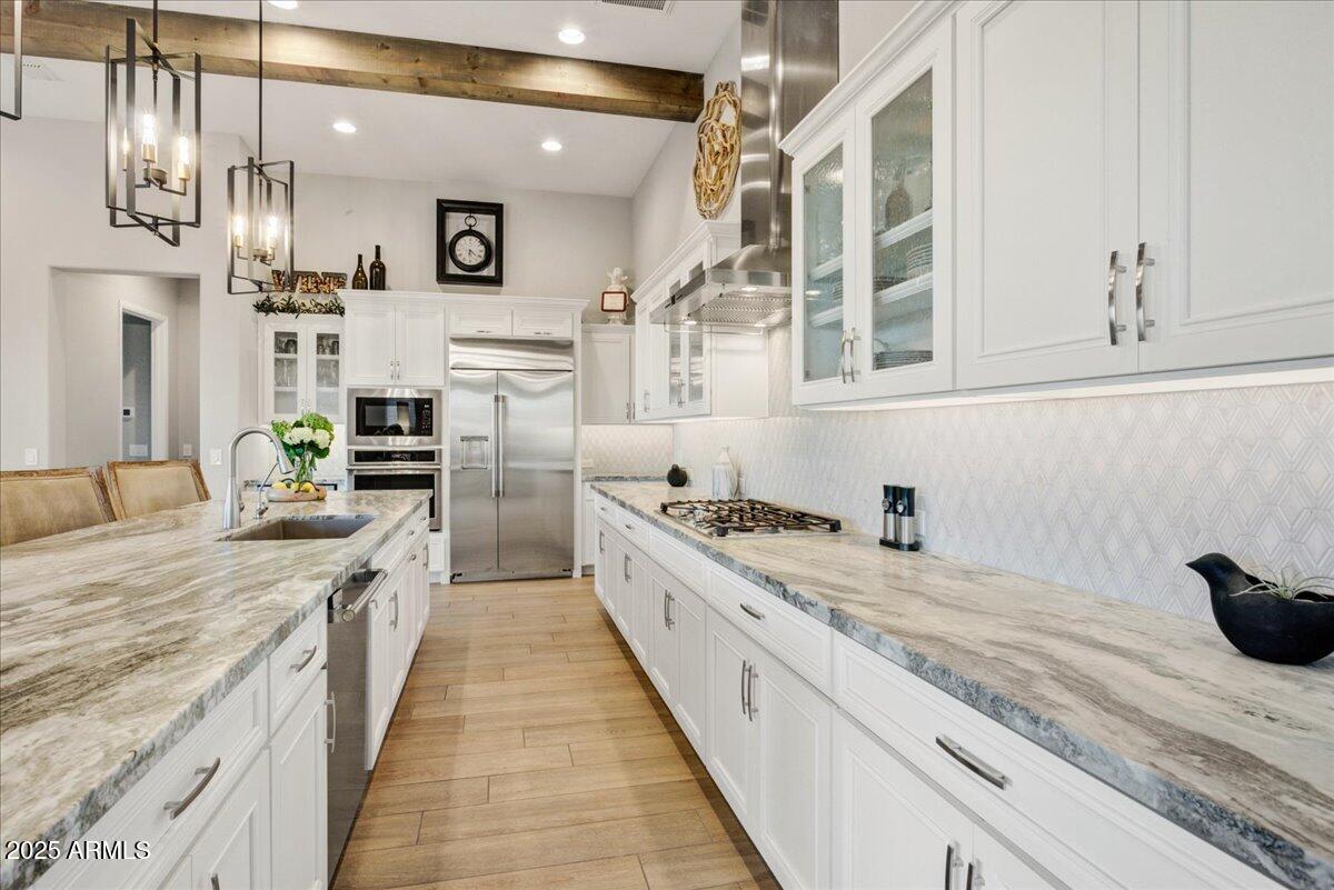 17833 East StockingTrail Rio Verde, AZ 85263 - Photo 7 of 45 a large kitchen with stainless steel appliances granite countertop a lot of counter space and wooden floors