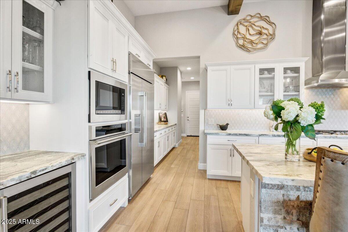 17833 East StockingTrail Rio Verde, AZ 85263 - Photo 8 of 45 a kitchen with stainless steel appliances kitchen island granite countertop a stove a sink and a microwave