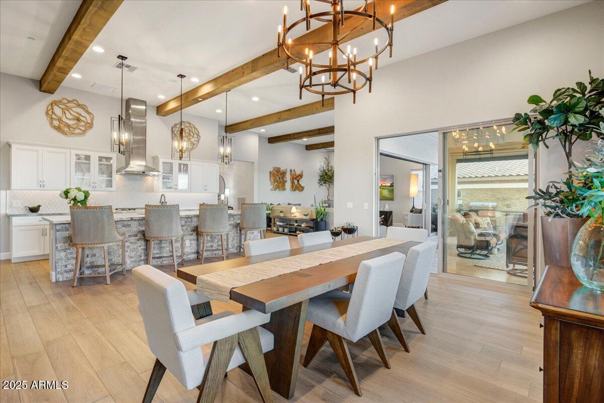 17833 East StockingTrail Rio Verde, AZ 85263 - Photo 10 of 45 a dining room with wooden floor a chandelier a wooden table and chairs