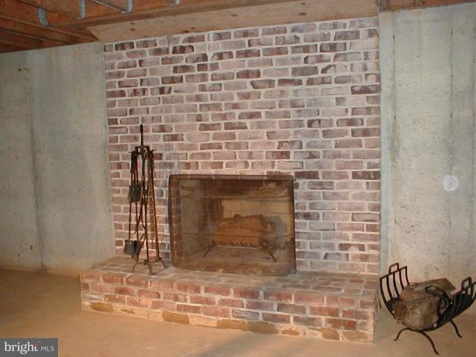 9509 Hall Road Potomac, MD 20854 - Photo 17 of 20 a room with a fireplace
