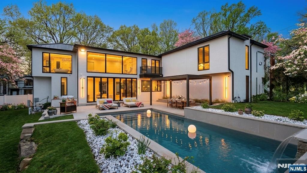 11 Roberts Road Englewood Cliffs, NJ 07632 - Photo 47 of 50 a front view of a house with swimming pool and furniture