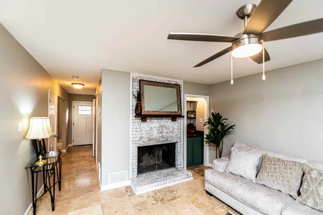 a living room with furniture a fireplace and a flat screen tv
