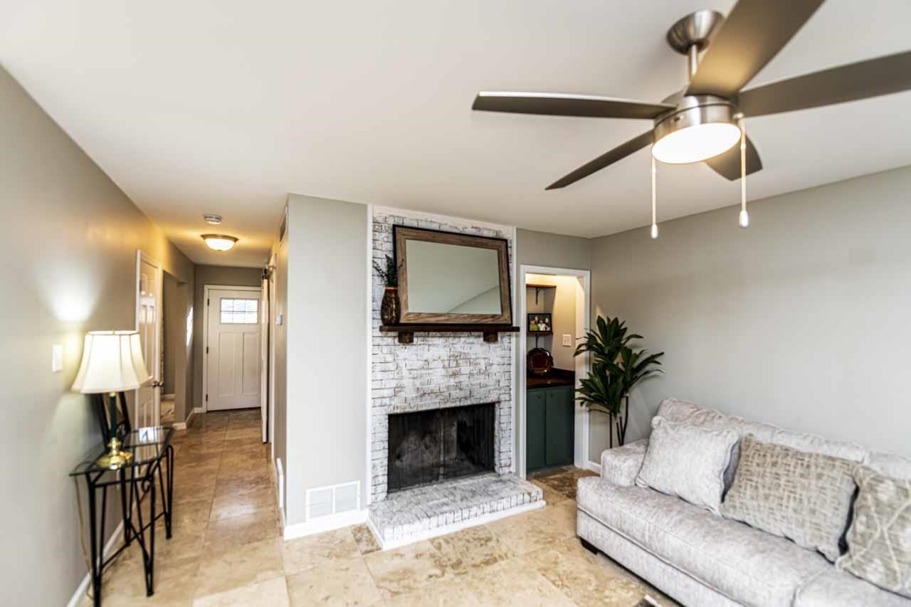 6910 Petworth Road, Unit 6910 Memphis, TN 38119 - Photo 12 of 37 a living room with furniture a fireplace and a flat screen tv