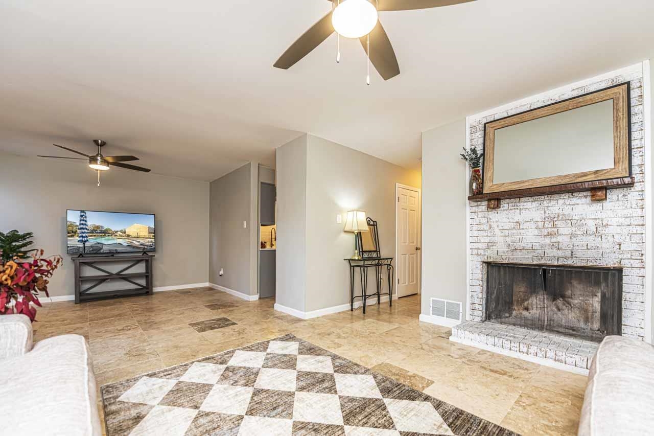 6910 Petworth Road, Unit 6910 Memphis, TN 38119 - Photo 13 of 37 a living room with furniture a flat screen tv and a fireplace