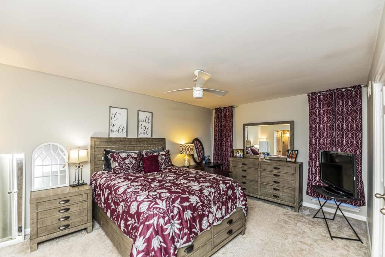 6910 Petworth Road, Unit 6910 Memphis, TN 38119 - Photo 17 of 37 a bedroom with a bed and a chandelier