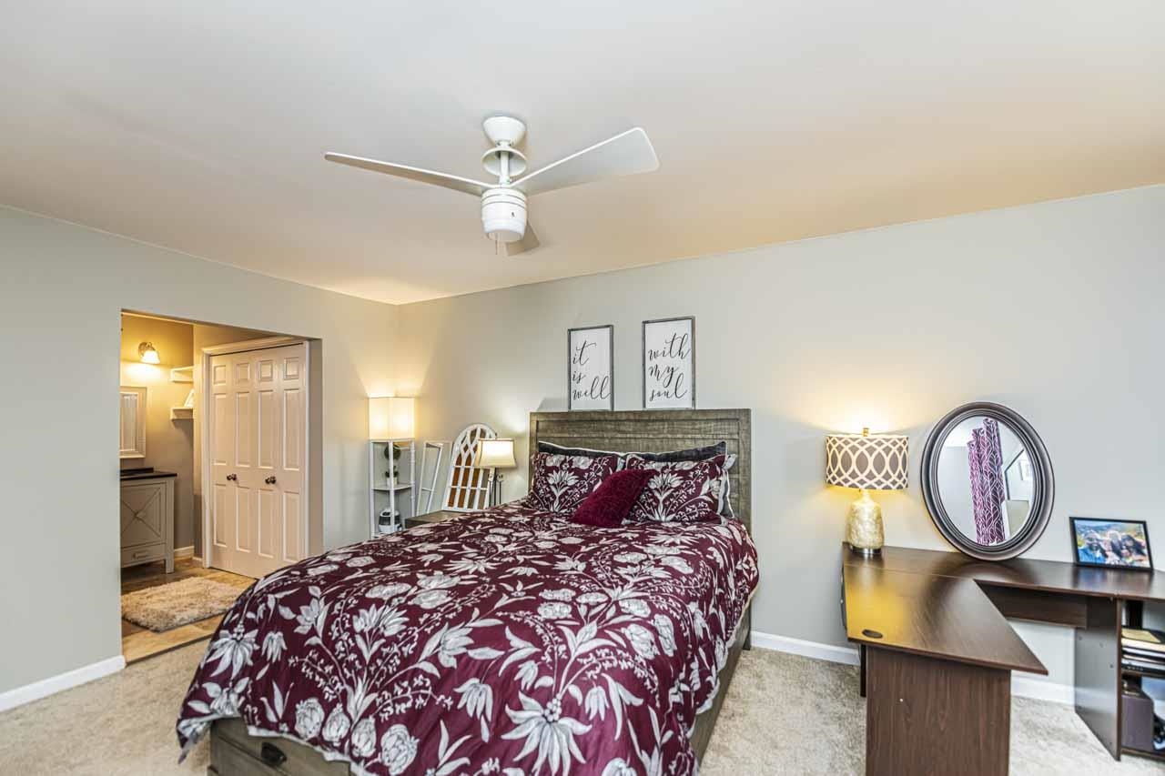 6910 Petworth Road, Unit 6910 Memphis, TN 38119 - Photo 18 of 37 a bedroom with a bed and a chandelier