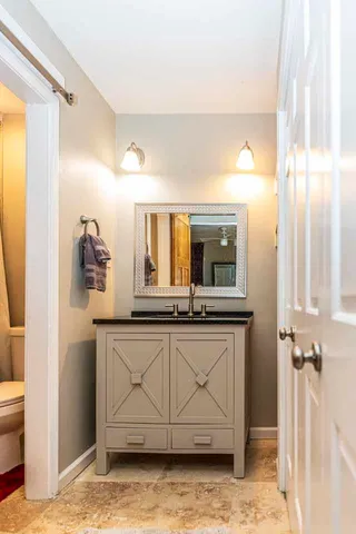 a bathroom with a sink a mirror and a toilet