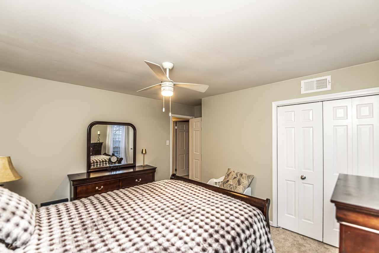 6910 Petworth Road, Unit 6910 Memphis, TN 38119 - Photo 23 of 37 a bedroom with a bed and a lamp on dresser