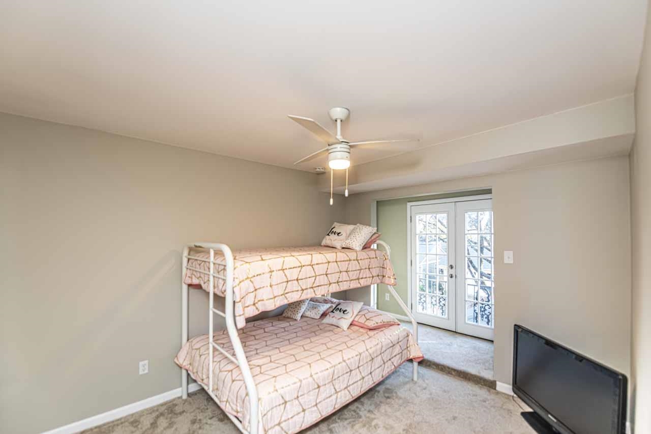 6910 Petworth Road, Unit 6910 Memphis, TN 38119 - Photo 24 of 37 a bedroom with a bed window and a chandelier