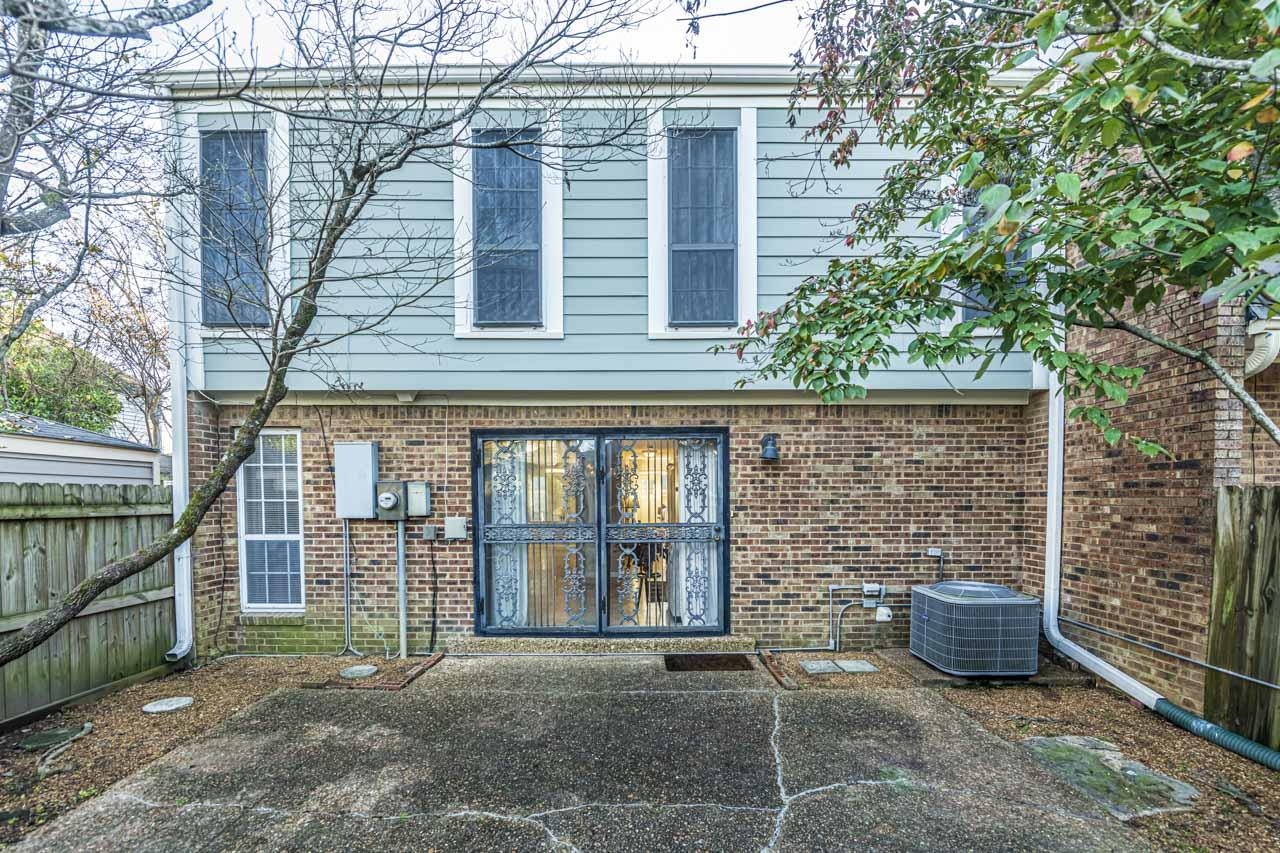 6910 Petworth Road, Unit 6910 Memphis, TN 38119 - Photo 28 of 37 a view of a brick house with a large window and wooden fence