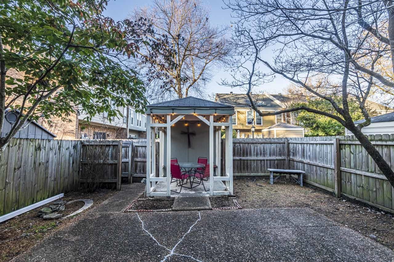 6910 Petworth Road, Unit 6910 Memphis, TN 38119 - Photo 30 of 37 a view of a backyard with a small cabin and a chair