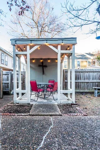 a view of a chairs with large trees
