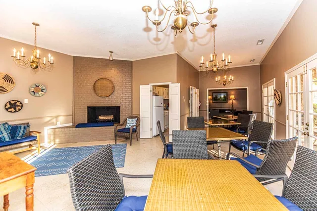 a living room with furniture a flat screen tv and kitchen view