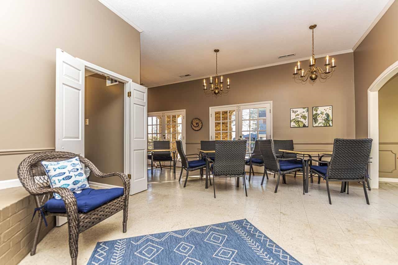 6910 Petworth Road, Unit 6910 Memphis, TN 38119 - Photo 34 of 37 a living room with furniture dining table and a chandelier