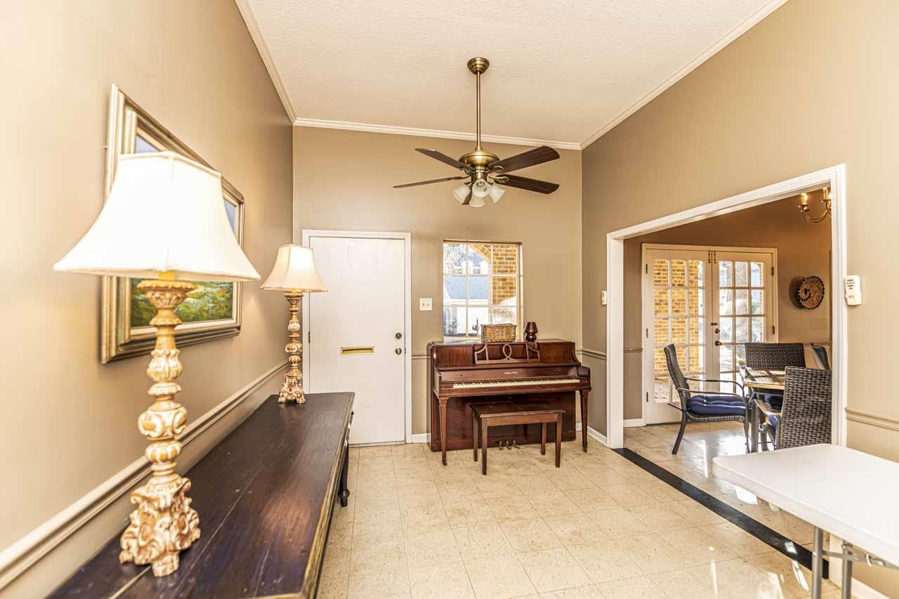 6910 Petworth Road, Unit 6910 Memphis, TN 38119 - Photo 35 of 37 a living room with furniture a piano and a flat screen tv