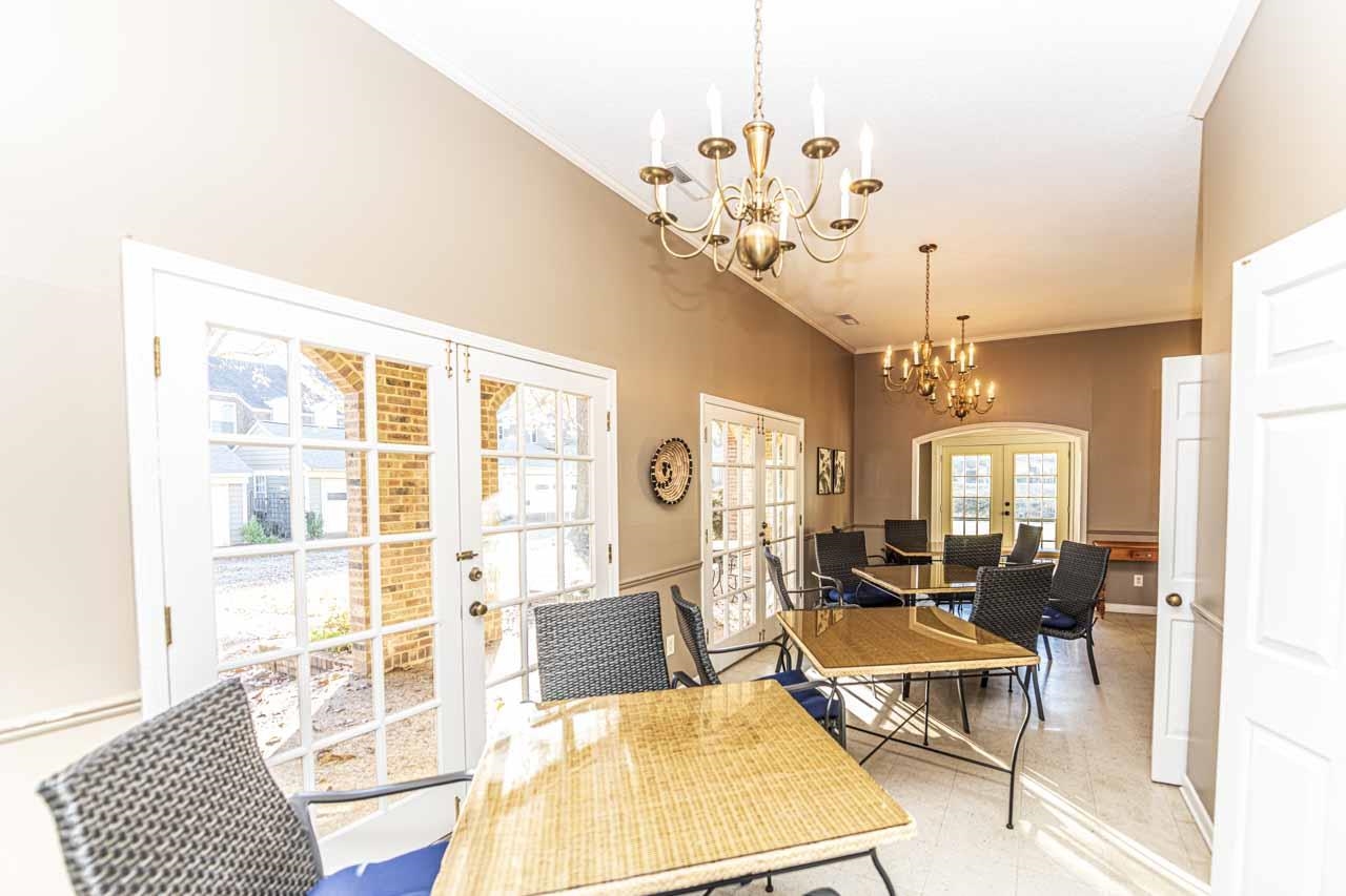 6910 Petworth Road, Unit 6910 Memphis, TN 38119 - Photo 36 of 37 a living room with furniture a chandelier and a dining table