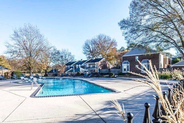 a view of a white house with a yard and sitting area