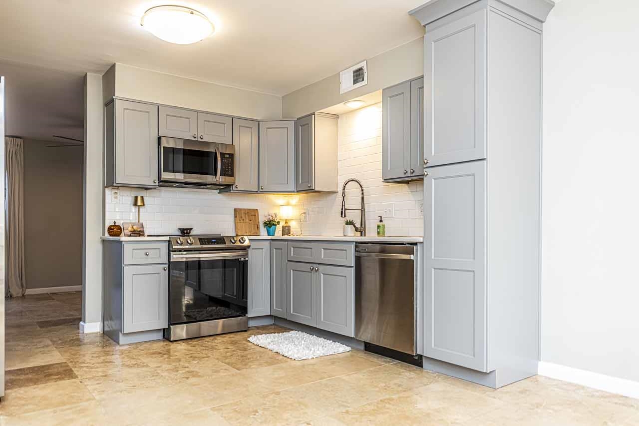 6910 Petworth Road, Unit 6910 Memphis, TN 38119 - Photo 6 of 37 a kitchen with kitchen island granite countertop a stove top oven and sink
