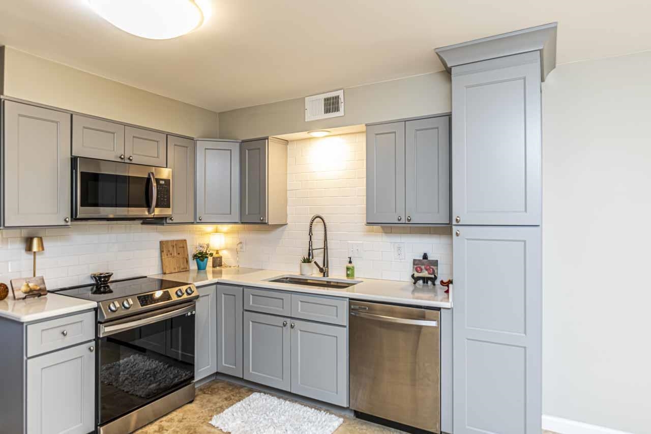 6910 Petworth Road, Unit 6910 Memphis, TN 38119 - Photo 8 of 37 a kitchen with stainless steel appliances granite countertop white cabinets granite counter tops and a stove