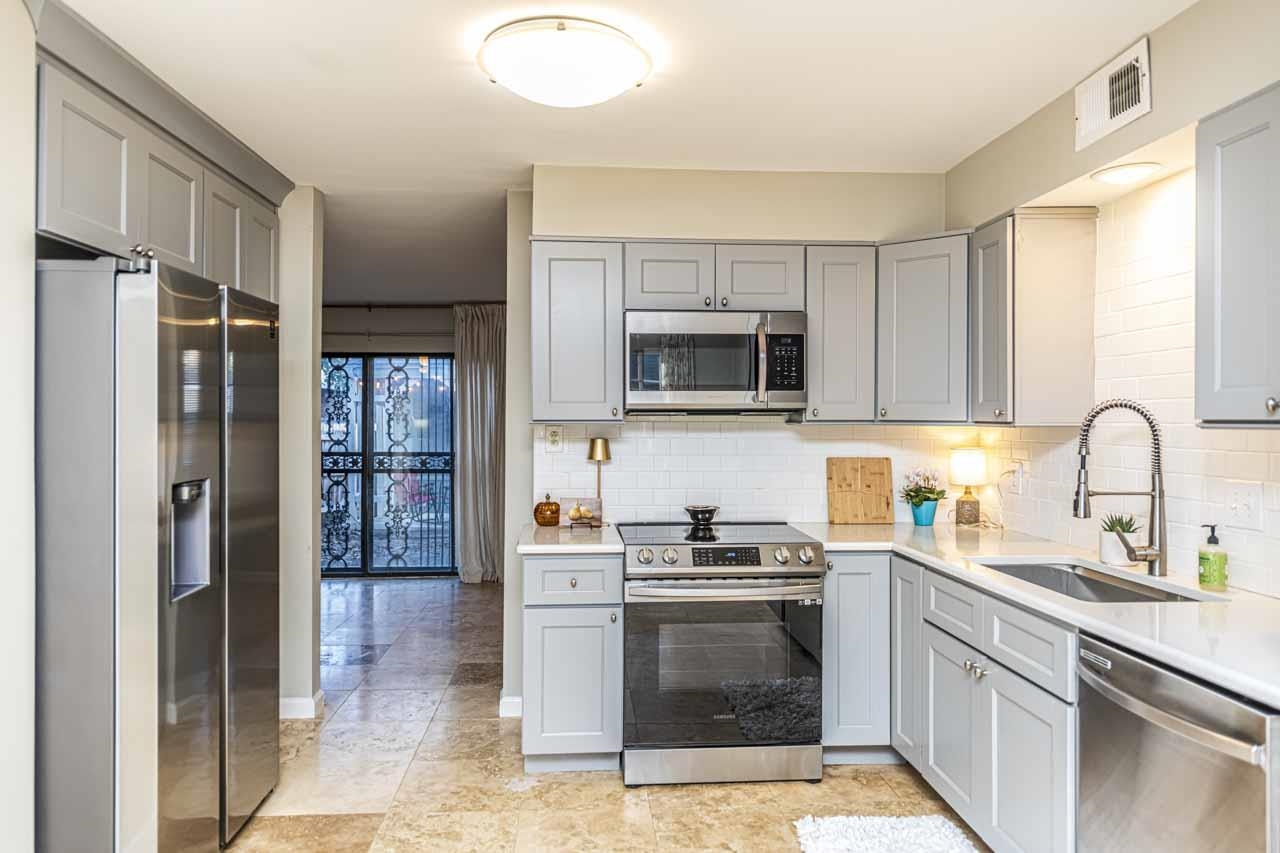 6910 Petworth Road, Unit 6910 Memphis, TN 38119 - Photo 9 of 37 a kitchen with stainless steel appliances granite countertop a refrigerator and a stove top oven