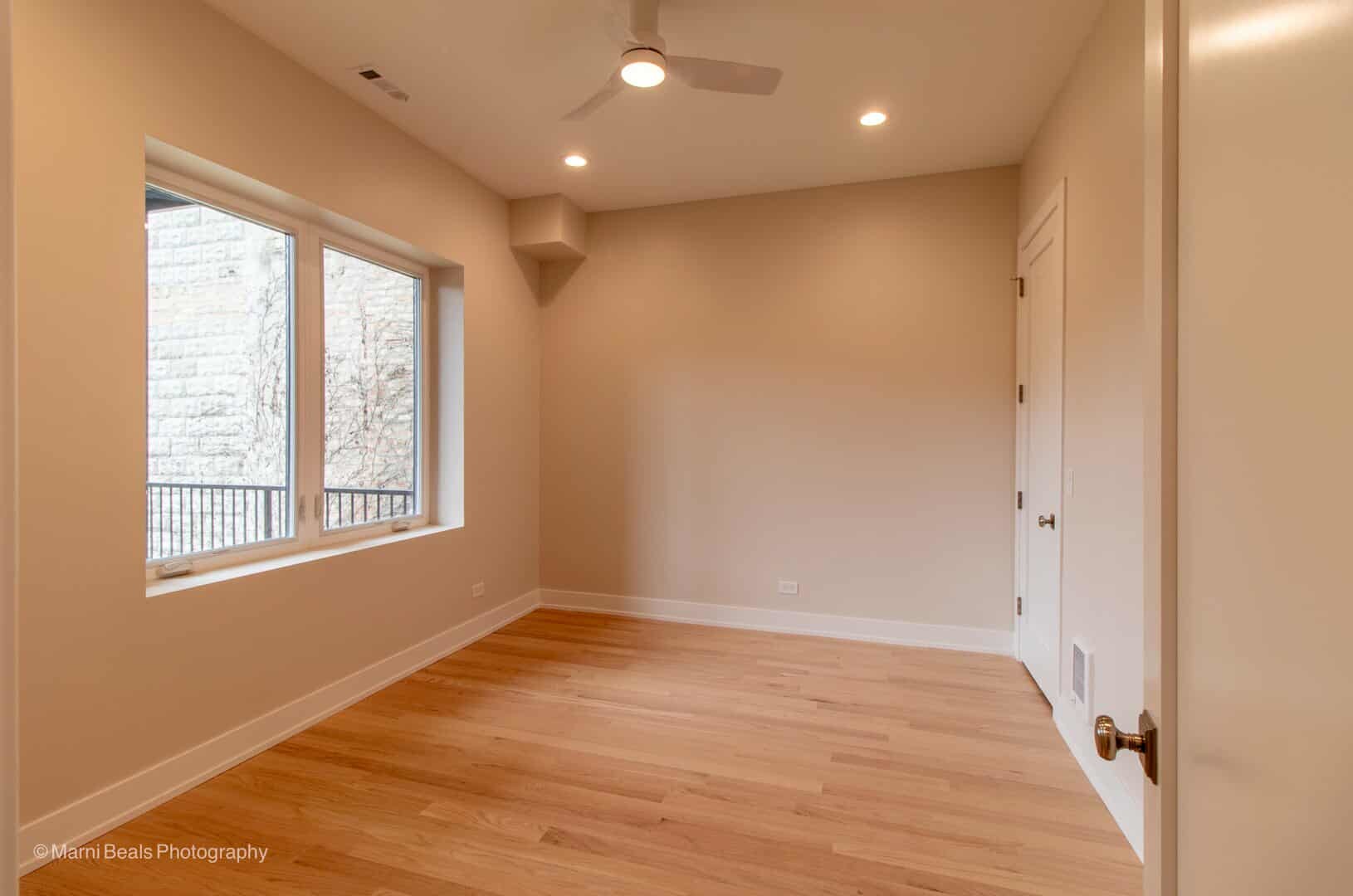 507 East 60th Street, Unit 1 Chicago, IL 60637 - Photo 11 of 15 a view of an empty room with wooden floor and a window