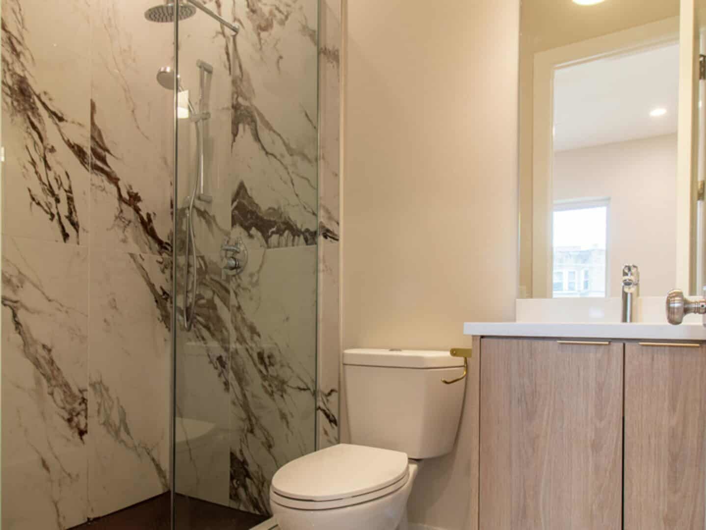 507 East 60th Street, Unit 1 Chicago, IL 60637 - Photo 12 of 15 a white toilet sitting next to a shower curtain