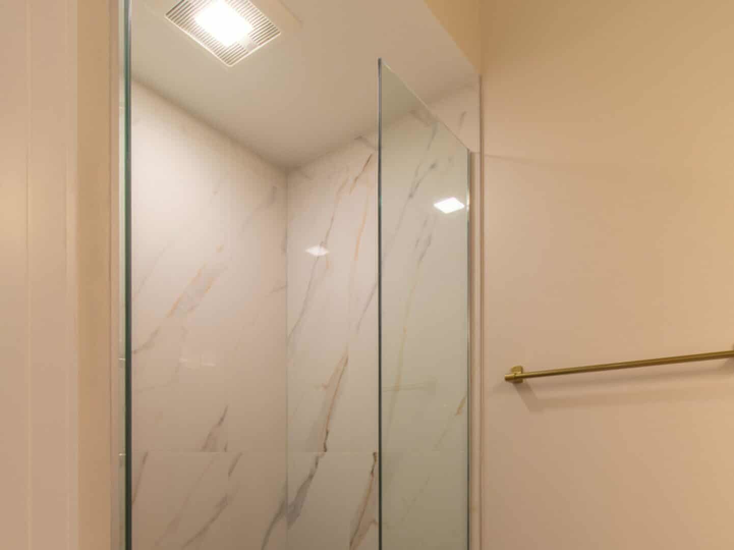 507 East 60th Street, Unit 1 Chicago, IL 60637 - Photo 8 of 15 a bathroom with a shower and a glass door