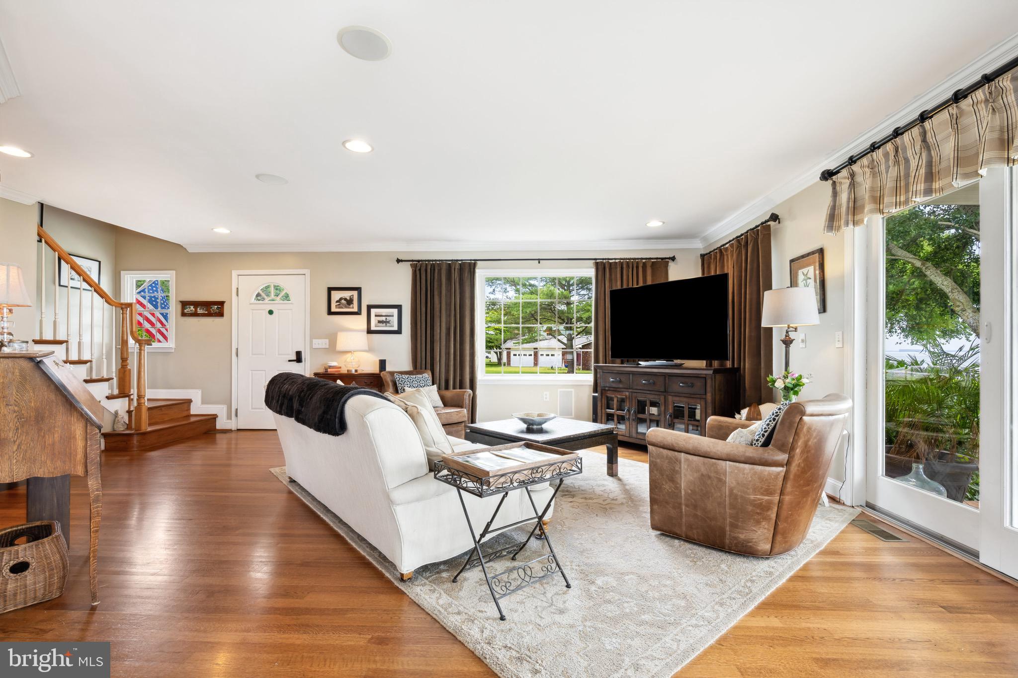 1606 Howard Road Chester, MD 21619 - Photo 12 of 54 a living room with furniture a flat screen tv and a large window