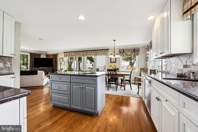 a kitchen with stainless steel appliances granite countertop sink stove top oven and cabinets