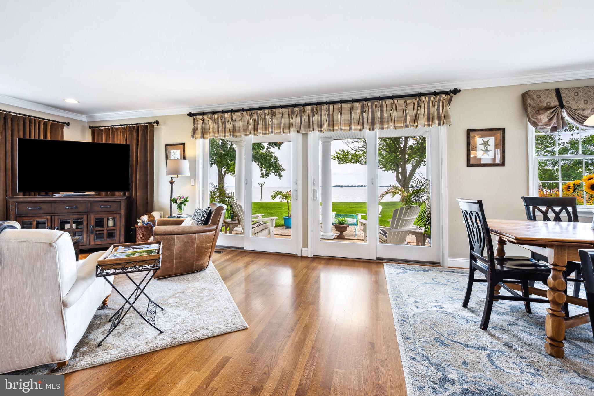 1606 Howard Road Chester, MD 21619 - Photo 2 of 54 a living room with furniture a flat screen tv and a floor to ceiling window