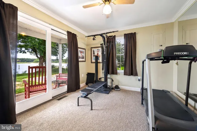 a living room with furniture and large windows
