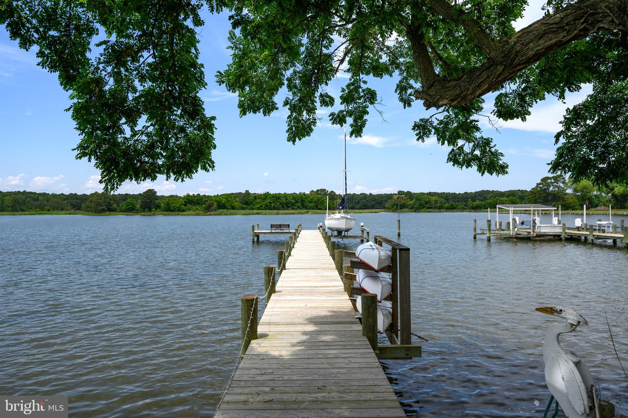1606 Howard Road Chester, MD 21619 - Photo 3 of 54 a wooden pier with boats in the lake