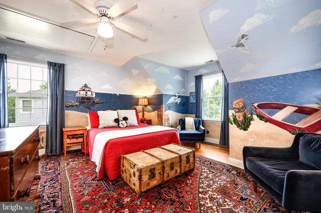 a front view of a house with a garden and trees