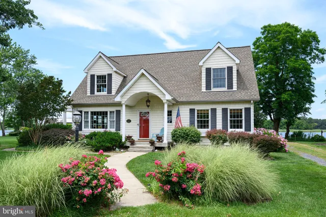 a view of a lake with lawn chairs