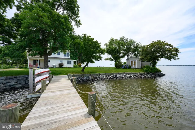 a view of green field with trees in the background