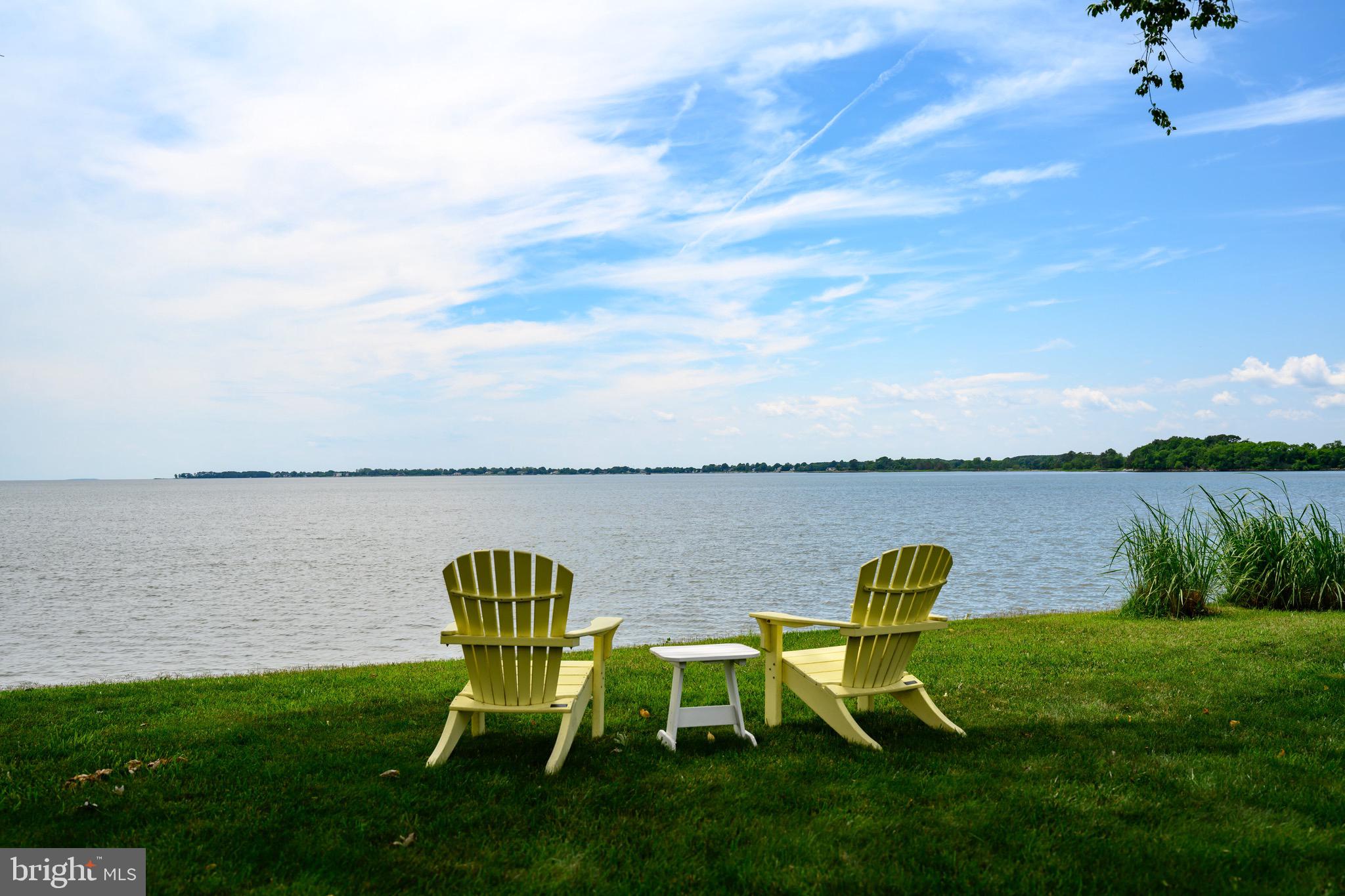 1606 Howard Road Chester, MD 21619 - Photo 4 of 54 a view of a lake with table and chairs