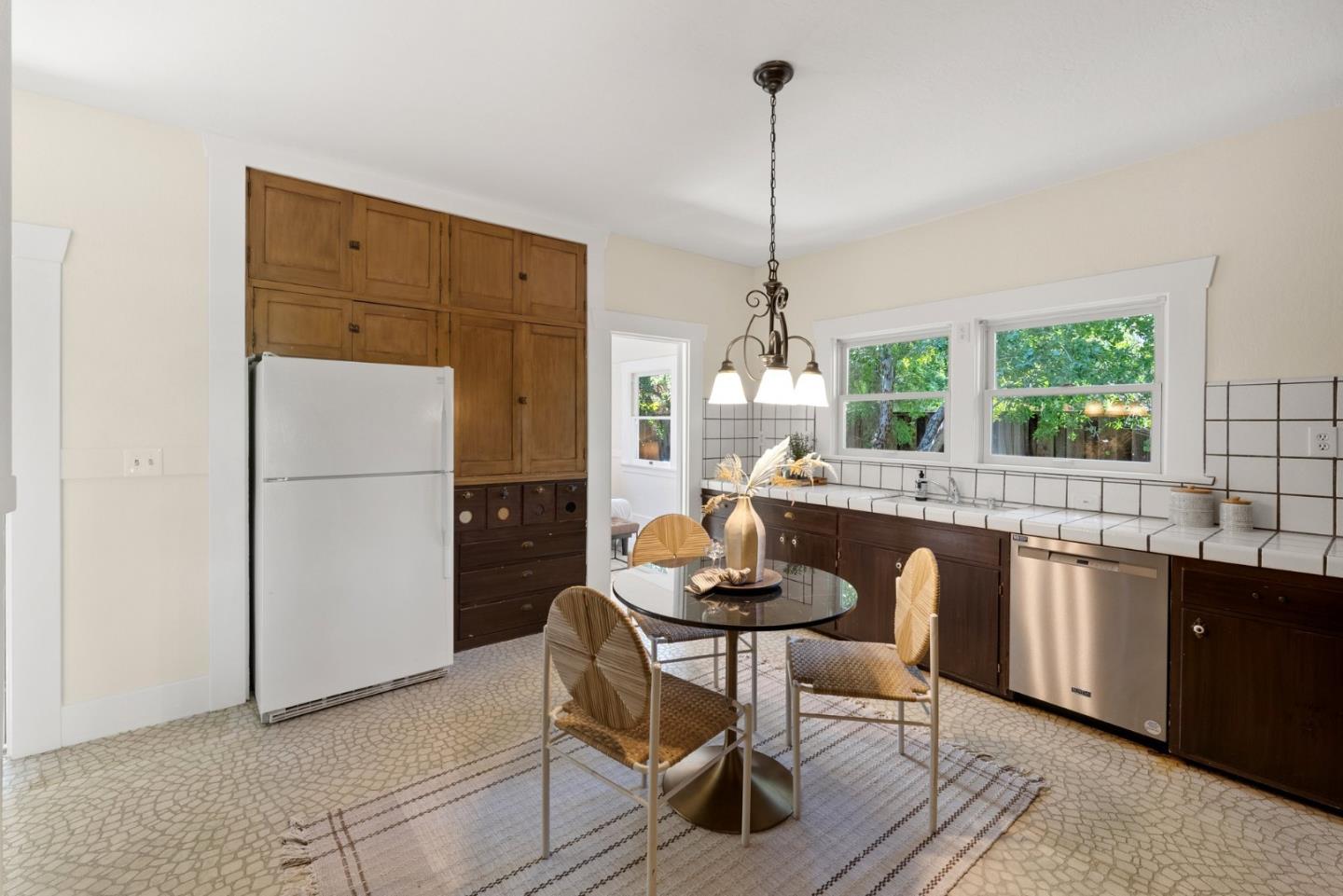 20724 Prospect Road Saratoga, CA 95070 - Photo 8 of 22 a kitchen with a dining table chairs and refrigerator