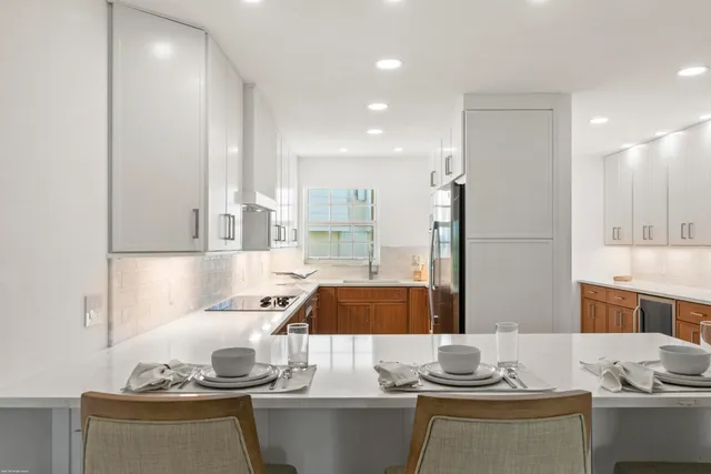 a kitchen with sink and cabinets
