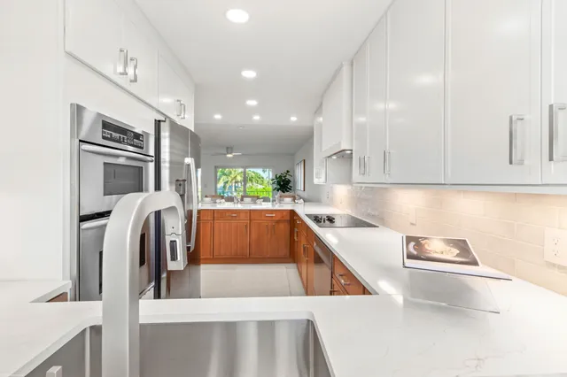 a kitchen with granite countertop cabinets stainless steel appliances and sink
