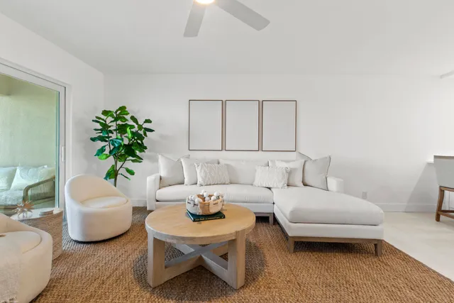 a living room with furniture and a potted plant