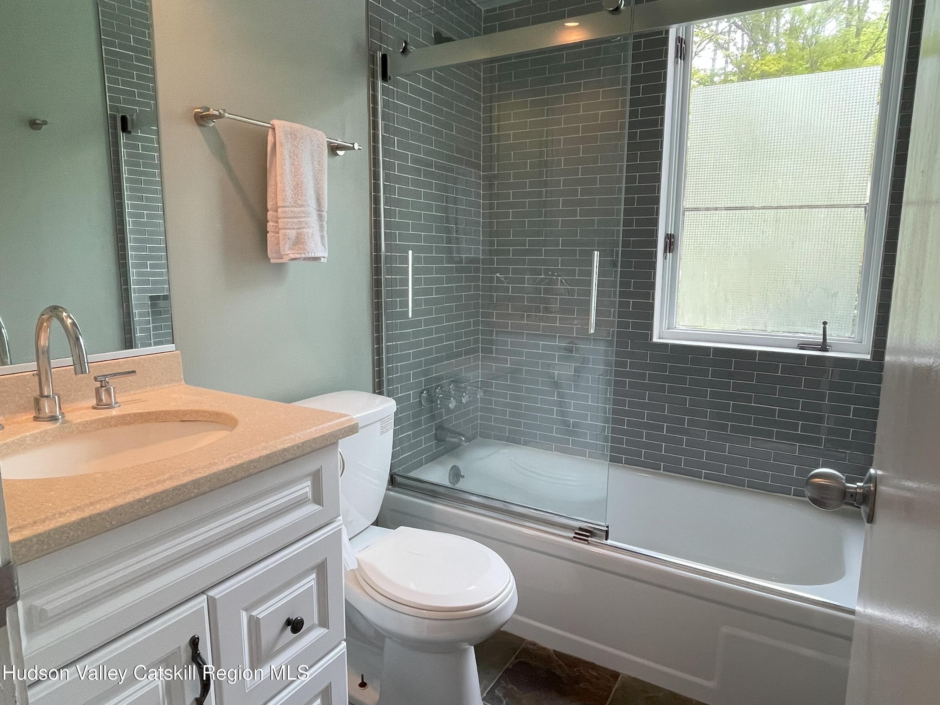 270 Pines Drive, Unit 92 Roxbury, NY 12421 - Photo 11 of 31 a bathroom with a sink a toilet and a bathtub