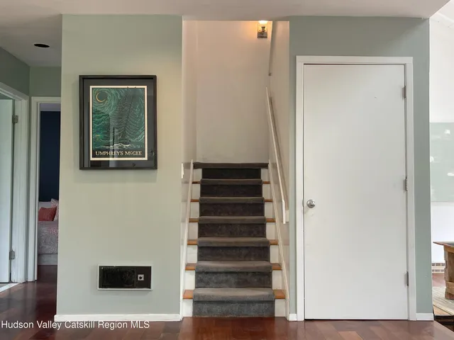 a view of entryway and hall with wooden floor
