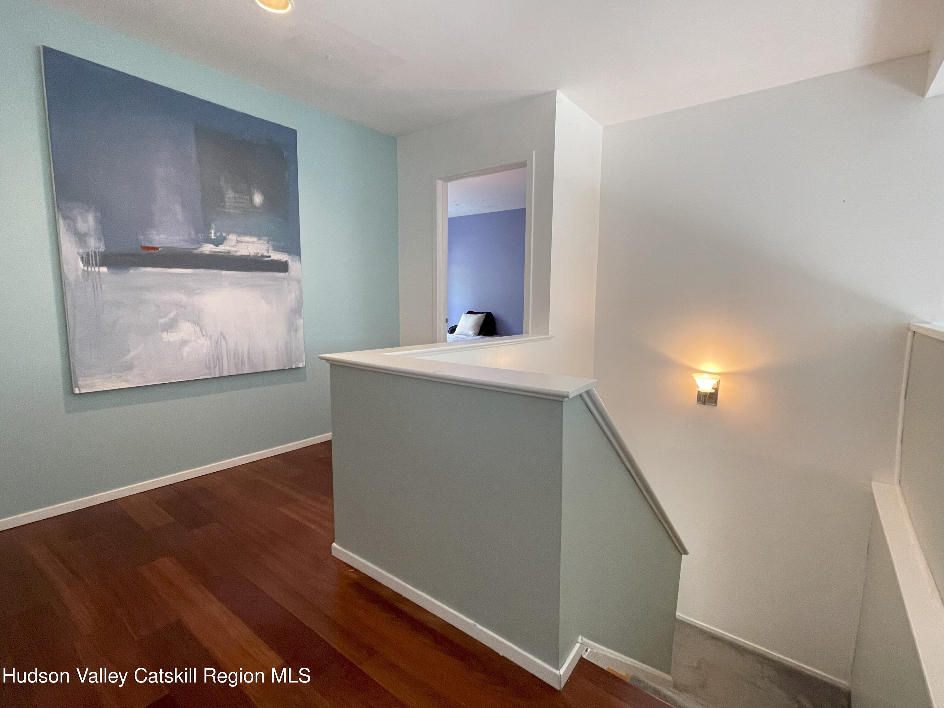 270 Pines Drive, Unit 92 Roxbury, NY 12421 - Photo 13 of 31 a view of an empty room with wooden floor and a window