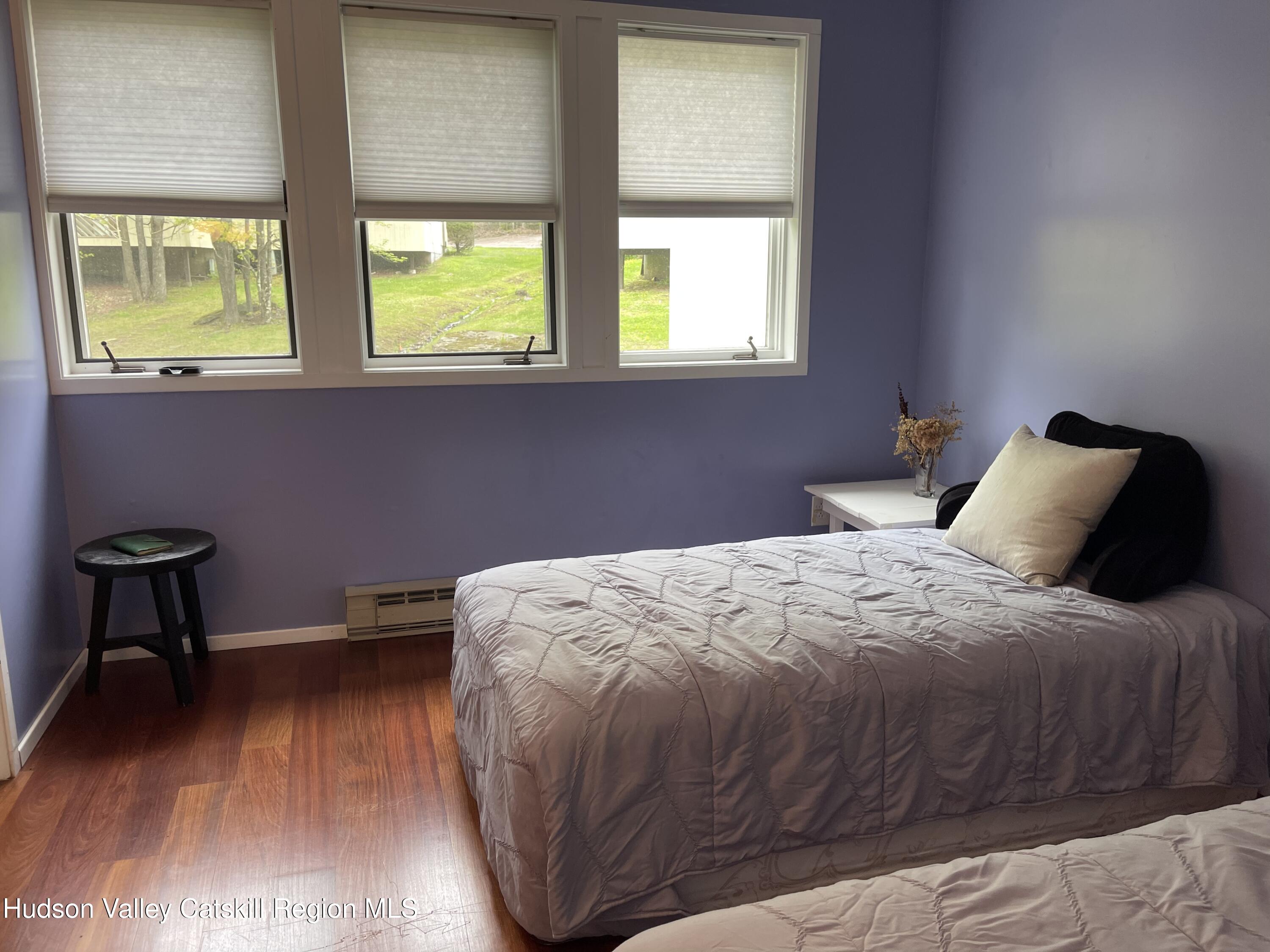 270 Pines Drive, Unit 92 Roxbury, NY 12421 - Photo 14 of 31 a bedroom with a bed and a window