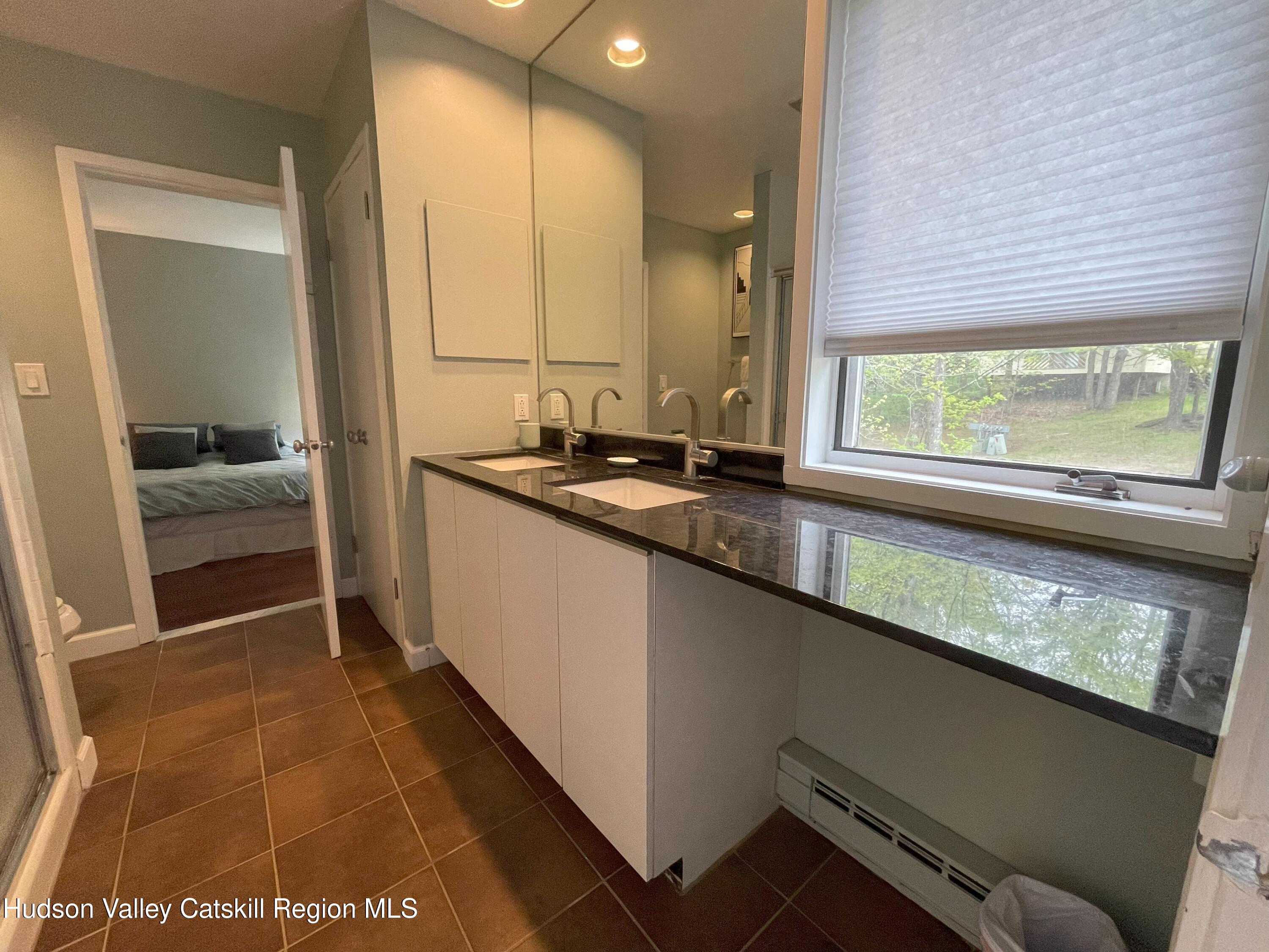 270 Pines Drive, Unit 92 Roxbury, NY 12421 - Photo 15 of 31 a bathroom with a sink and a mirror