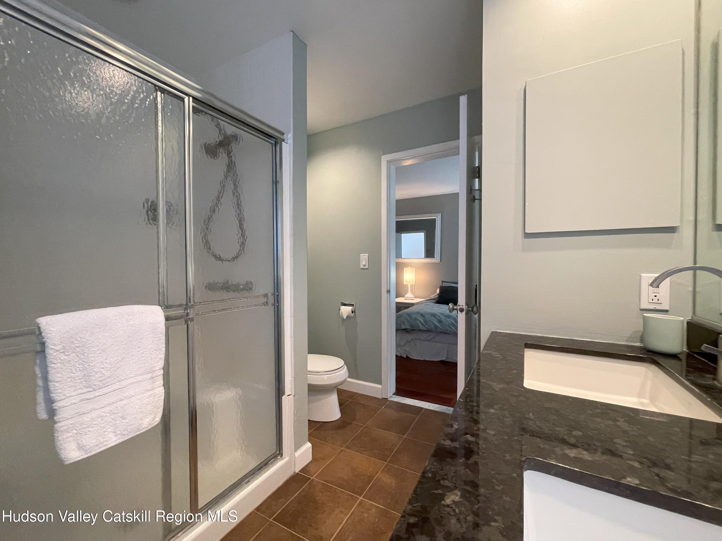 270 Pines Drive, Unit 92 Roxbury, NY 12421 - Photo 16 of 31 a bathroom with a granite countertop sink toilet and shower