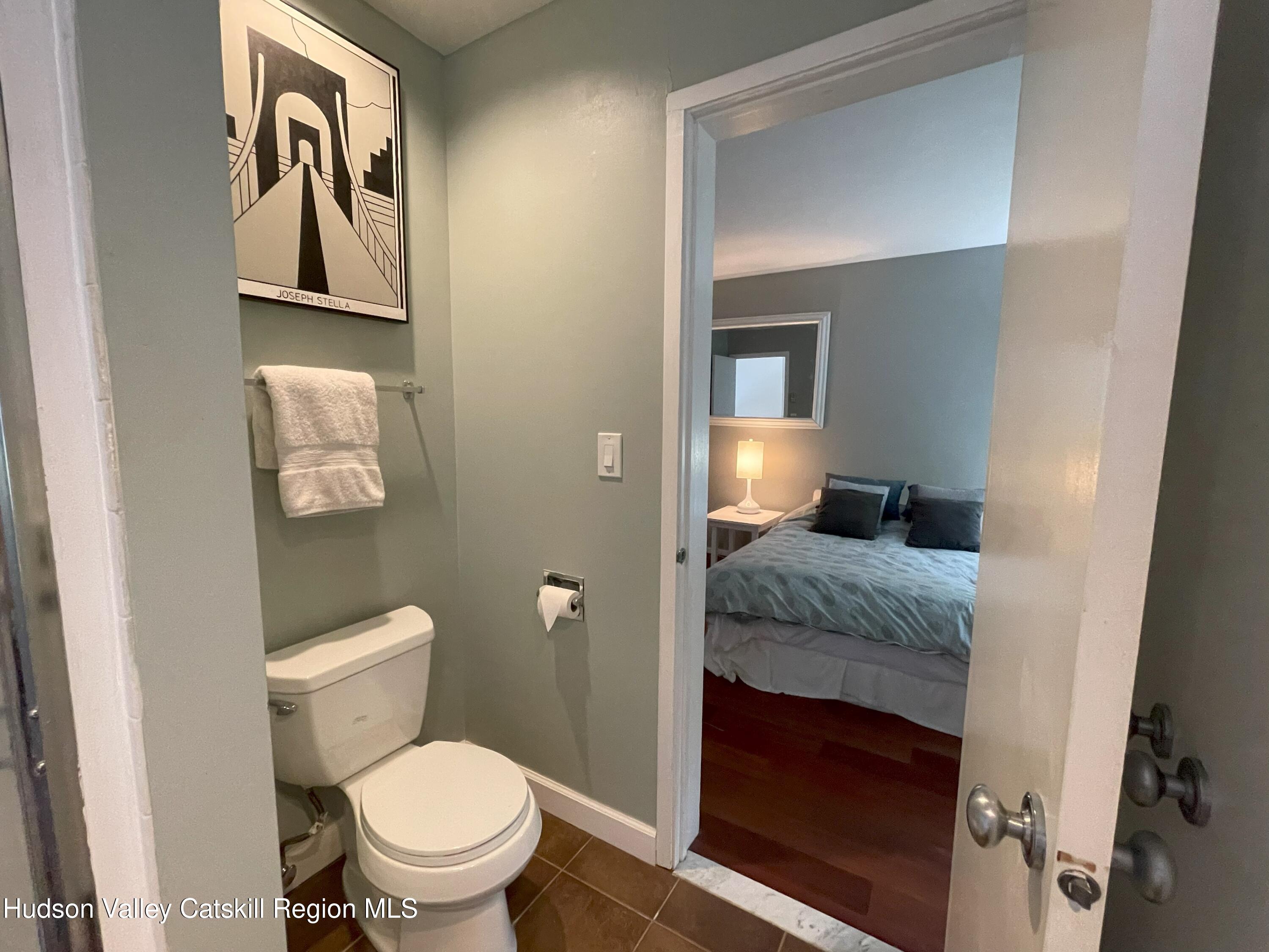270 Pines Drive, Unit 92 Roxbury, NY 12421 - Photo 17 of 31 a bathroom with a granite countertop toilet and a sink